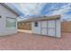 Exterior view of detached storage shed in backyard with painted door and small window at 13368 W Rimrock St, Surprise, AZ 85374