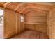 Interior view of storage shed, featuring wooden walls, shelving, and small window at 13368 W Rimrock St, Surprise, AZ 85374
