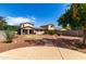 Backyard featuring a walkway, rock landscaping, and a lawn at 13602 N 149Th Ave, Surprise, AZ 85379