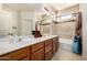 Bathroom featuring double sinks, light tile, and shower/tub combo at 13602 N 149Th Ave, Surprise, AZ 85379