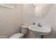 Small bathroom includes a pedestal sink and a toilet at 13602 N 149Th Ave, Surprise, AZ 85379