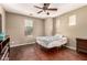 Bedroom featuring hardwood floors, ceiling fan, and a window at 13602 N 149Th Ave, Surprise, AZ 85379