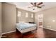 Bedroom featuring hardwood floors and a ceiling fan at 13602 N 149Th Ave, Surprise, AZ 85379
