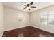 Bedroom featuring hardwood floors, two windows, and neutral colored walls at 13602 N 149Th Ave, Surprise, AZ 85379
