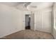 Neutral bedroom featuring a ceiling fan, carpet, and sliding door closet at 13602 N 149Th Ave, Surprise, AZ 85379