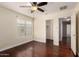 Bedroom featuring hardwood floors, a ceiling fan, and a closet at 13602 N 149Th Ave, Surprise, AZ 85379