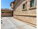 Side exterior view of the home highlighting the stucco siding and adjacent three car garage at 13602 N 149Th Ave, Surprise, AZ 85379