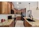 Bright kitchen with wood cabinetry, granite counters, and stainless steel appliances at 13602 N 149Th Ave, Surprise, AZ 85379