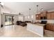 Open-concept kitchen with granite countertops, wooden cabinets, and seamless view into the living area at 13602 N 149Th Ave, Surprise, AZ 85379