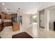Spacious kitchen with dark appliances, wood cabinets, island with granite countertops, and bright lighting at 13602 N 149Th Ave, Surprise, AZ 85379