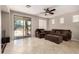 Comfortable living room featuring a large plush sectional, ceiling fan, and easy access to the backyard at 13602 N 149Th Ave, Surprise, AZ 85379