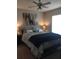 Cozy bedroom with a ceiling fan, a comfy bed, and colorful wall art at 14145 N 92Nd St # 2011, Scottsdale, AZ 85260