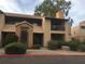 Charming apartment building exterior with stairs, tiled roofs, well-kept landscaping and tan stucco at 14145 N 92Nd St # 2011, Scottsdale, AZ 85260