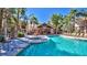 Resort-style pool area with lounge chairs, a covered patio, and lush landscaping offers a relaxing outdoor space at 14145 N 92Nd St # 2011, Scottsdale, AZ 85260