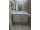 Well-lit bathroom with a double sink vanity and tiled floors at 14841 W Desert Hills Dr, Surprise, AZ 85379