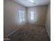 Cozy bedroom with plush carpeting and natural light from two windows at 14841 W Desert Hills Dr, Surprise, AZ 85379