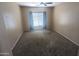 Comfortable bedroom featuring plush carpet, neutral walls, and a bright window view at 14841 W Desert Hills Dr, Surprise, AZ 85379