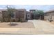 Charming single-story home featuring a well-kept yard and a spacious driveway for easy parking at 14841 W Desert Hills Dr, Surprise, AZ 85379