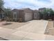 Inviting single-Gathering home with a two-car garage, attractive landscaping, and a welcoming entrance at 14841 W Desert Hills Dr, Surprise, AZ 85379