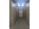 Bright hallway with neutral colors, tiled floors, transom windows, and an attractive light fixture at 14841 W Desert Hills Dr, Surprise, AZ 85379