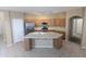 Open kitchen with a large island, stainless steel appliances, and ample counter space at 14841 W Desert Hills Dr, Surprise, AZ 85379