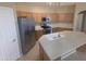 Functional kitchen boasts stainless steel appliances, a large island, and abundant cabinet storage at 14841 W Desert Hills Dr, Surprise, AZ 85379