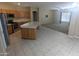Open concept kitchen and living room area with ample space, neutral colors, and a ceiling fan at 14841 W Desert Hills Dr, Surprise, AZ 85379