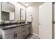 Bathroom with dual sinks, black faucets and gray cabinetry, offering style and functionality at 16 W Encanto Blvd # 110, Phoenix, AZ 85003