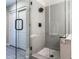 Modern tiled shower with glass doors and black shower fixtures, complemented by mosaic tile flooring at 16 W Encanto Blvd # 110, Phoenix, AZ 85003