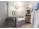 A modern bathroom features a glass shower, soaking tub, and sleek vanity at 16 W Encanto Blvd # 110, Phoenix, AZ 85003