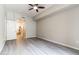 Bright bedroom featuring hardwood floors and a ceiling fan and a doorway to the ensuite bathroom at 16 W Encanto Blvd # 110, Phoenix, AZ 85003