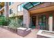 Inviting brick entrance with lush landscaping and a covered entryway, enhancing curb appeal at 16 W Encanto Blvd # 110, Phoenix, AZ 85003