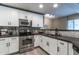 Updated kitchen features stainless steel appliances, black countertops, and white cabinets at 16 W Encanto Blvd # 110, Phoenix, AZ 85003