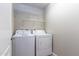 Laundry room featuring modern washer and dryer with shelving for organized storage at 16 W Encanto Blvd # 110, Phoenix, AZ 85003