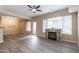 Bright living room with modern ceiling fan, fireplace, and door to the outside at 16 W Encanto Blvd # 110, Phoenix, AZ 85003
