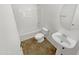 Clean, bright bathroom features a shower-tub combination, pedestal sink, and coordinated tile flooring at 18148 W Lundberg St, Surprise, AZ 85388
