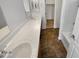 A Bathroom featuring dual vanity sinks, a walk in closet and modern faucets at 18148 W Lundberg St, Surprise, AZ 85388