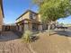 Charming two-story home with a landscaped front yard, enhancing its curb appeal and creating a welcoming entrance at 18148 W Lundberg St, Surprise, AZ 85388