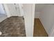 Hallway with carpeted closet space and neutral-toned tile flooring at 18148 W Lundberg St, Surprise, AZ 85388