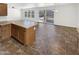 Kitchen with bar seating that opens to the backyard at 18148 W Lundberg St, Surprise, AZ 85388