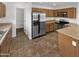 Well-equipped kitchen with wooden cabinets, stainless steel appliances, and ample counter space for meal preparation at 18148 W Lundberg St, Surprise, AZ 85388
