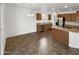 Open concept kitchen with stainless steel appliances and ample counter space with eat in nook at 18148 W Lundberg St, Surprise, AZ 85388