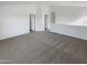 Upstairs loft area features neutral carpeting, natural lighting, and multiple entry ways at 18148 W Lundberg St, Surprise, AZ 85388