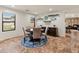 Charming dining area with a round table, upholstered chairs, and floating shelves, creating a cozy and inviting space at 18542 W Valerie Dr, Surprise, AZ 85374