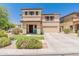 Inviting two-story home with a well-manicured lawn and a charming blue porch bench, perfect for enjoying sunny days at 18542 W Valerie Dr, Surprise, AZ 85374