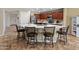 Spacious kitchen with a large island, seating, stainless steel appliances, and dark cabinets, ideal for cooking and entertaining at 18542 W Valerie Dr, Surprise, AZ 85374