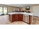 Modern kitchen island with stainless steel appliances, seating, and an open view into the inviting living area at 18542 W Valerie Dr, Surprise, AZ 85374