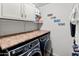 Laundry room with a modern washer and dryer, cabinets, and countertop at 18542 W Valerie Dr, Surprise, AZ 85374
