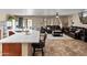 Open-concept living area with a spacious kitchen island and a comfortable living room featuring a plush leather couch at 18542 W Valerie Dr, Surprise, AZ 85374