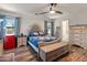 Large main bedroom with two windows, wood-look floors, and a ceiling fan at 18542 W Valerie Dr, Surprise, AZ 85374